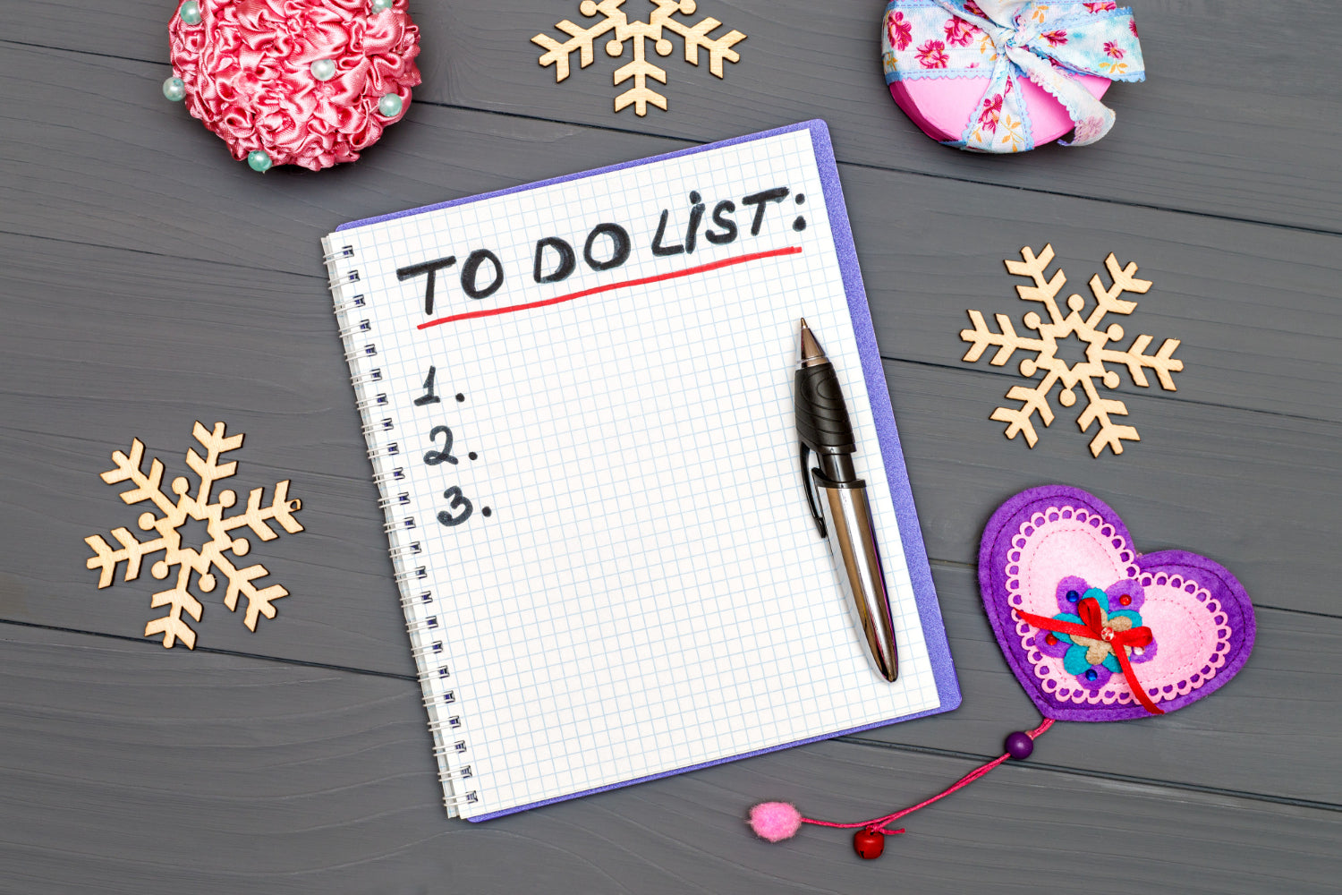 New Year to-do-list on wooden desk surface.