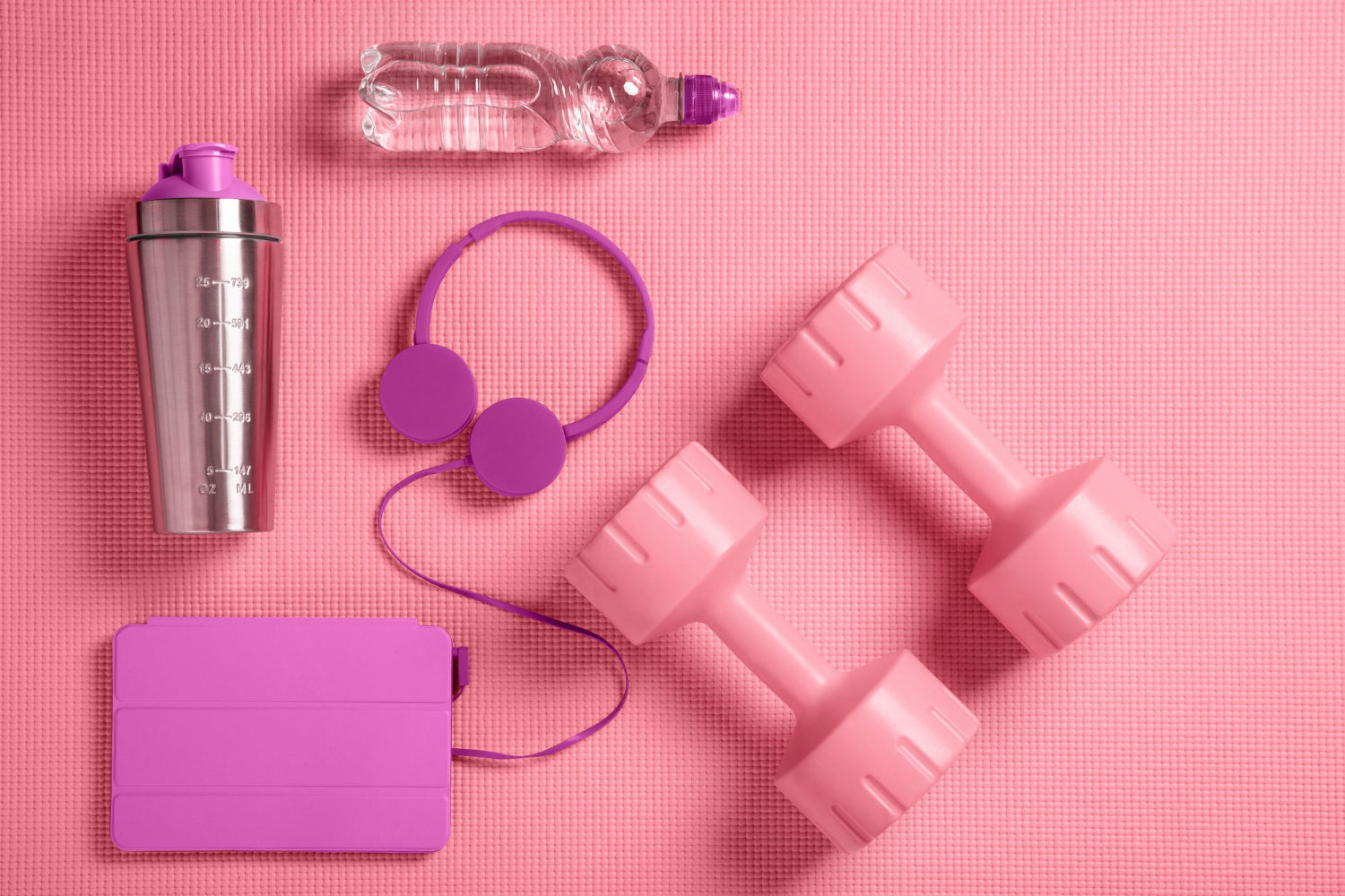 Fitness accessories including pink dumbbells, headphones, protein shaker, and fitness mat.