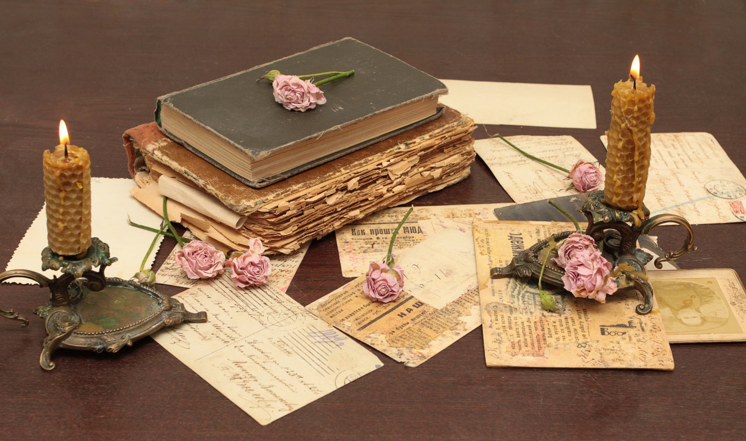 A vintage notebook with ornate designs and a rustic leather binding, placed next to an old fountain pen.