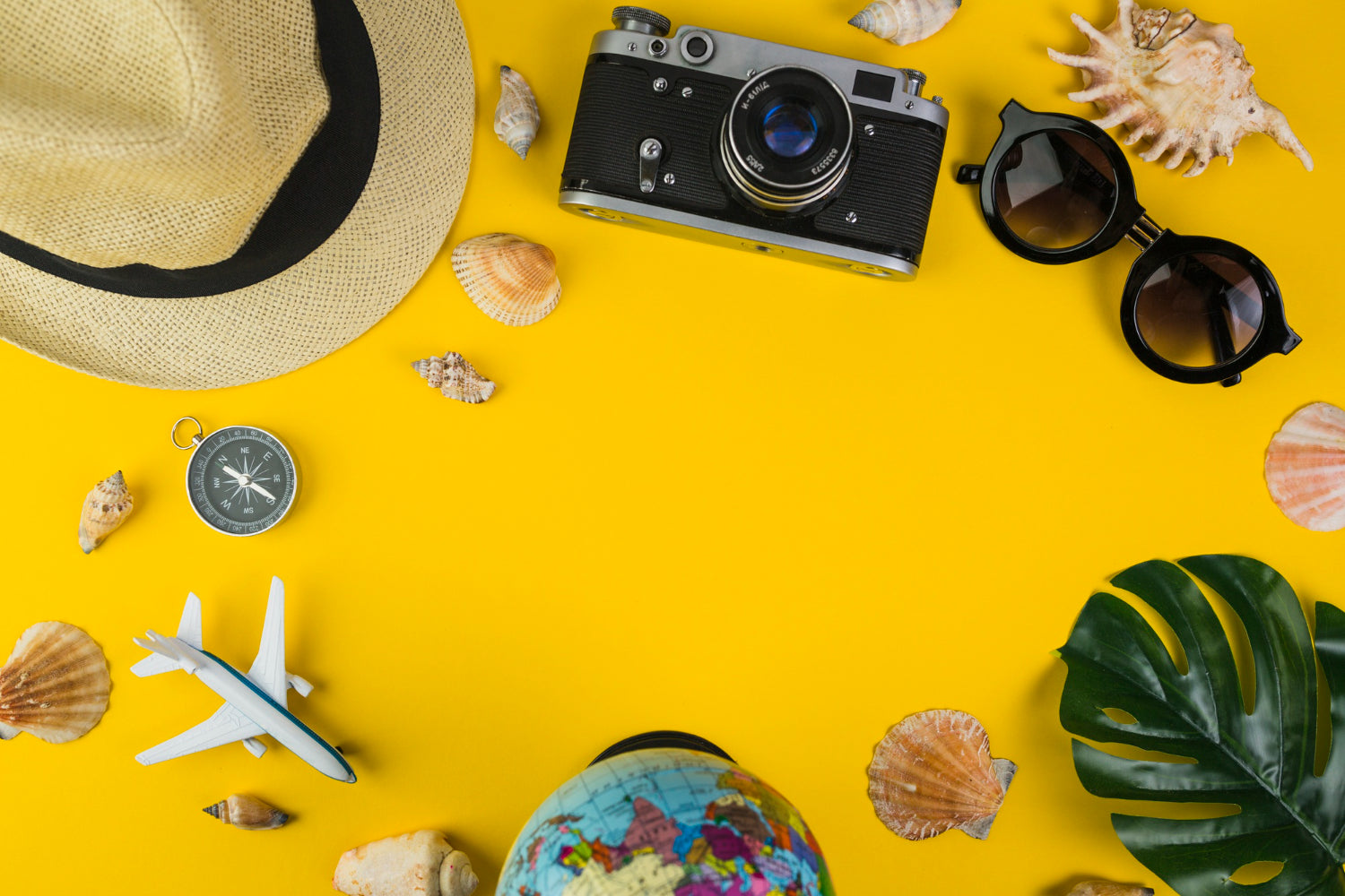 Traveler's Equipments with Seashell on Yellow Background.