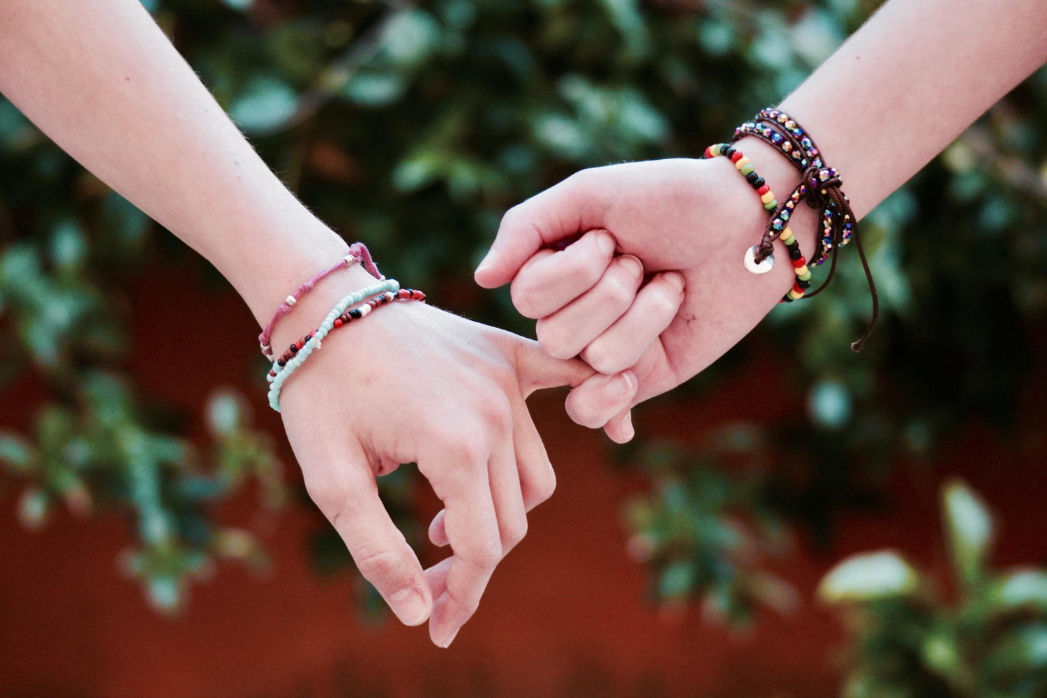 Two individuals holding hands, symbolizing connection, friendship, and unity.