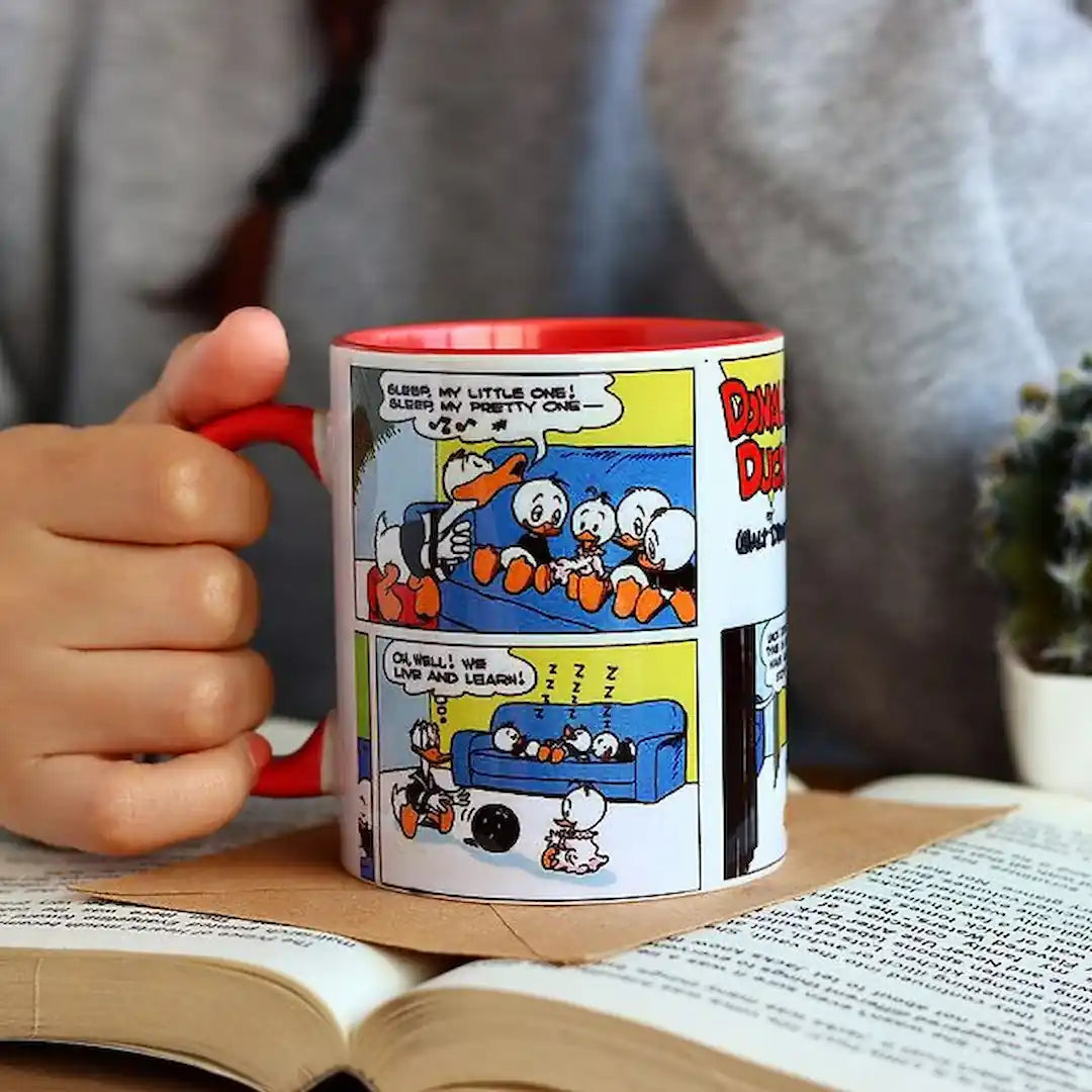 Graphic mug with Donald Duck design.